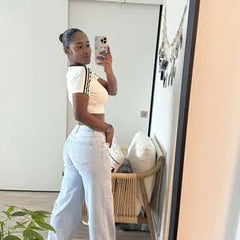 Customer wearing light-wash Sculpt Jeans, mirror selfie